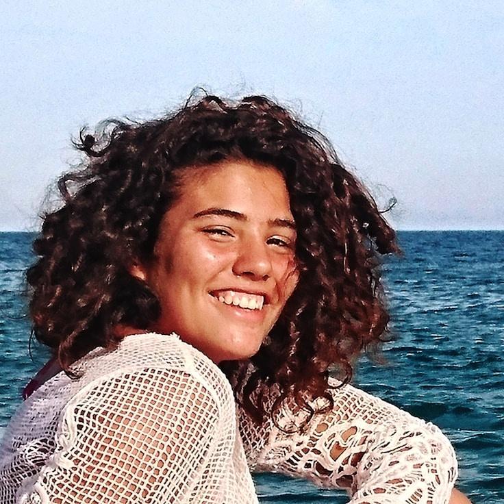 Alex Rao, Head of Design Curation at Echo Chamber Lab, reviewing corporate floral arrangements